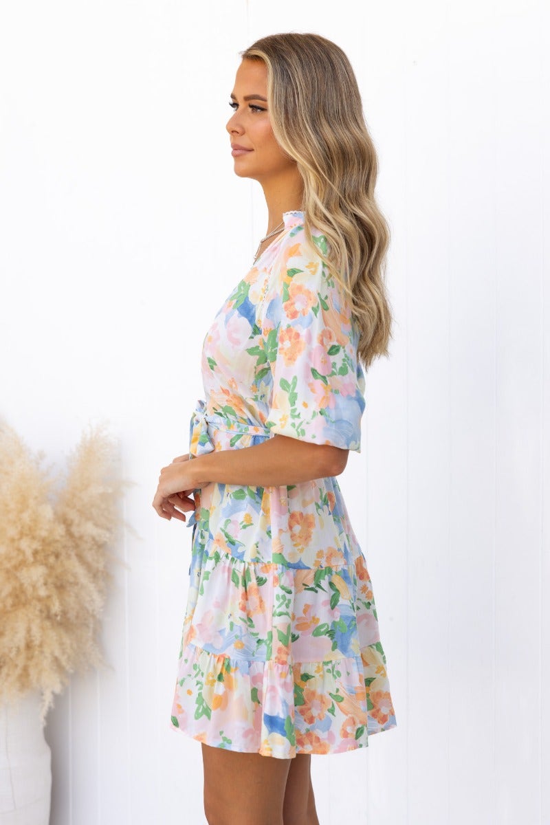 Harbin floral print dress with V-neckline and button-up front, featuring elastic sleeve cuffs and removable belt.