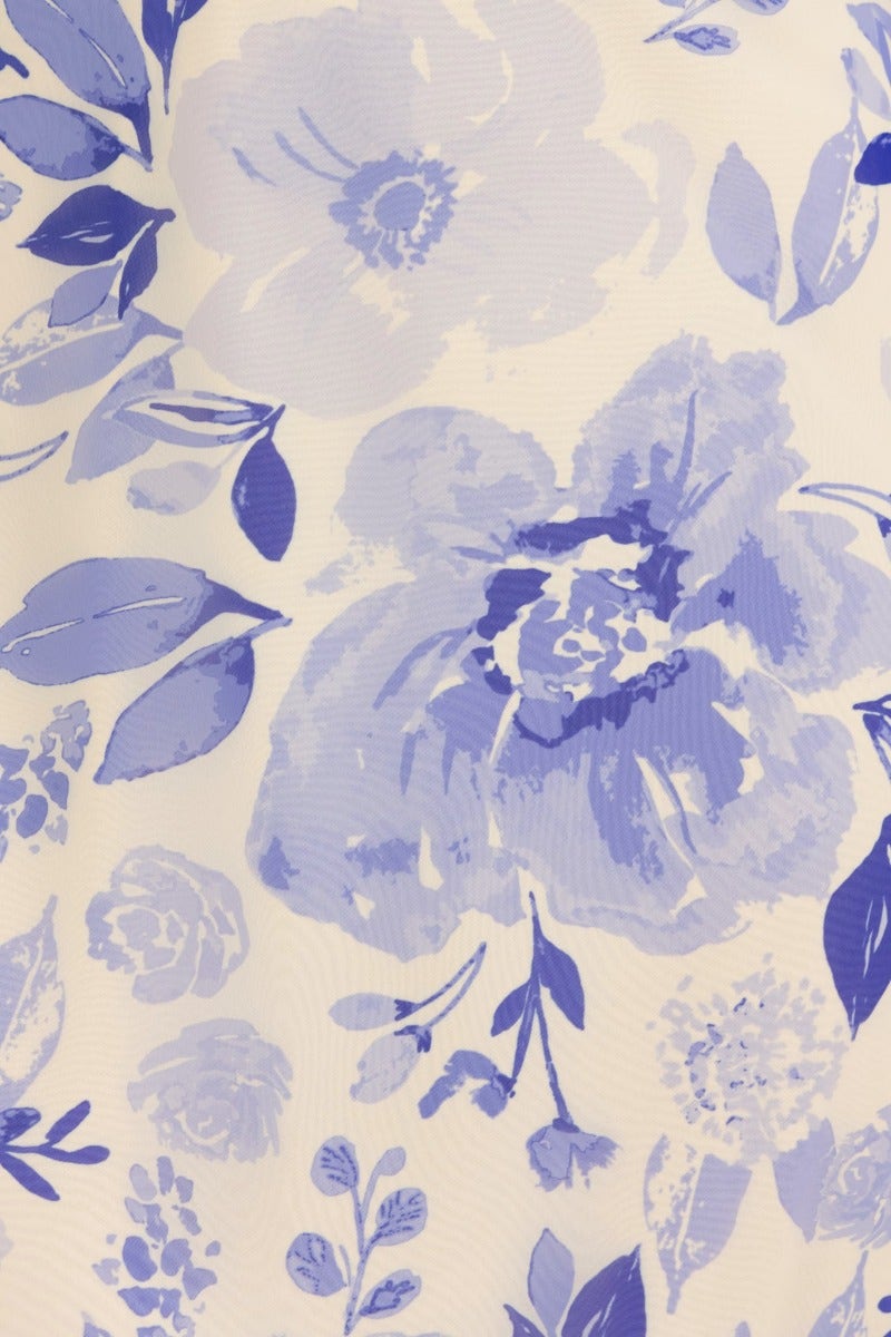 Floral print fabric in soft blue tones, featuring various flowers and leaves on a cream background.