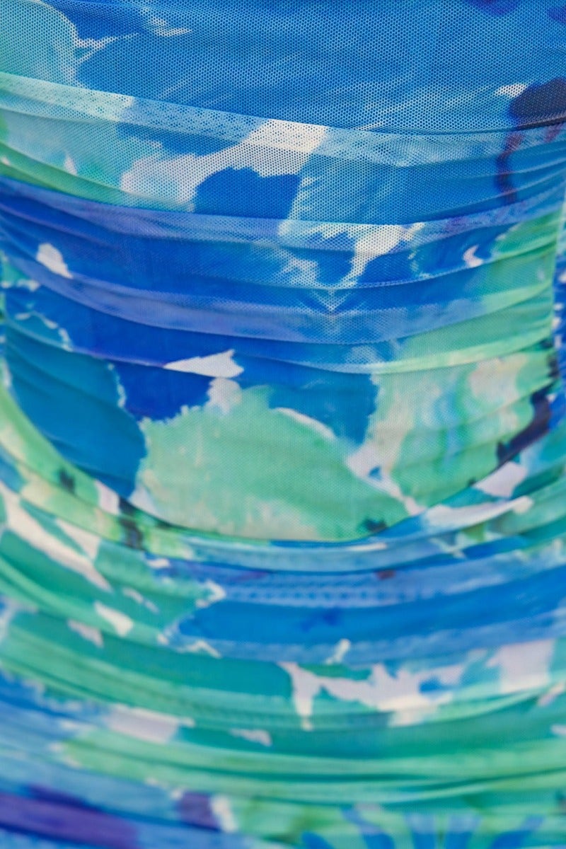 Close-up of the ruched fabric in various shades of blue and green from the Out Loud Dress.