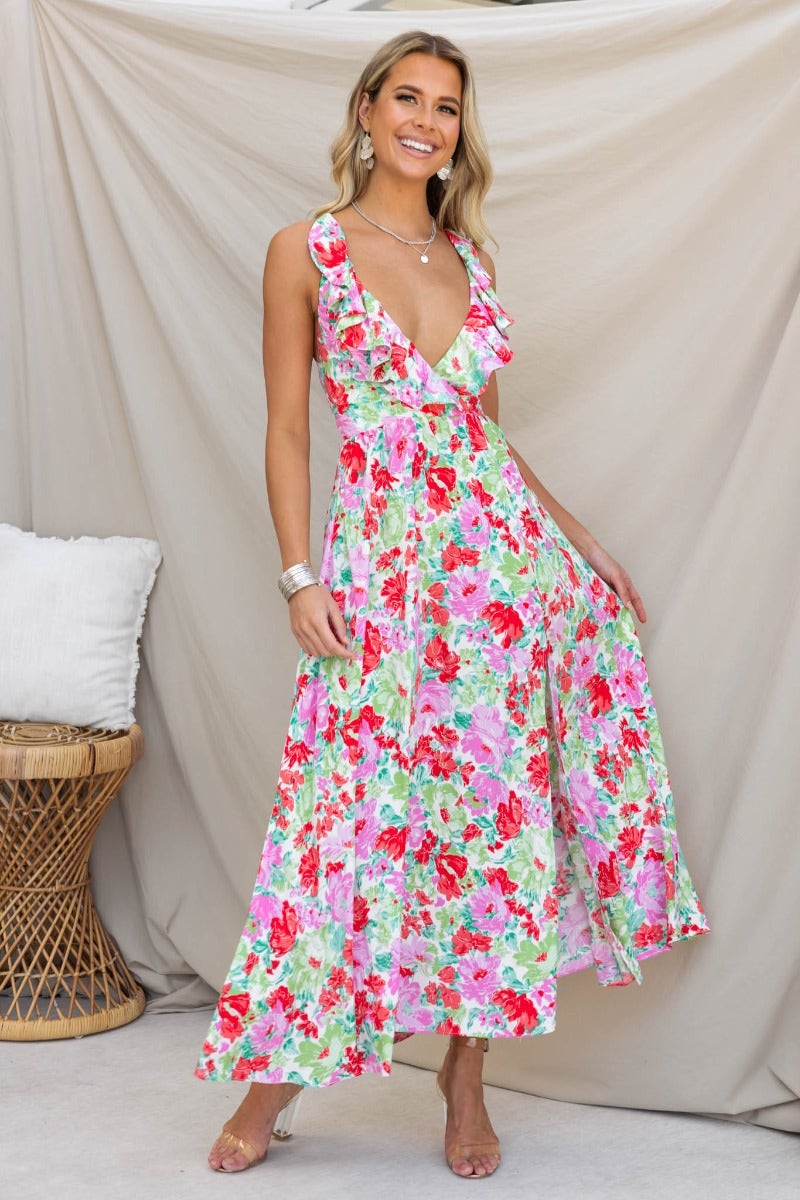 Floral print Swish Maxi Dress with V-neckline and adjustable straps, model wearing a vibrant style against a neutral backdrop.