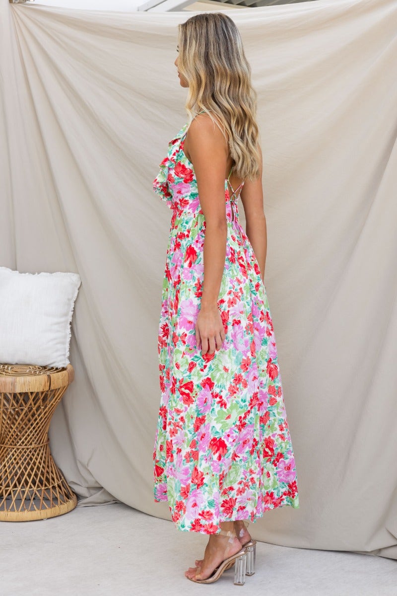 Floral print Swish Maxi Dress with V-neckline and adjustable tie straps, shown from the side in vibrant colors.