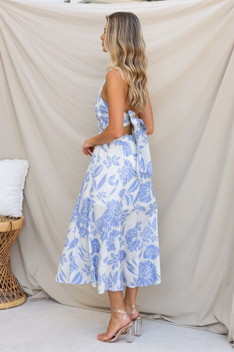 Elegant Corio Midi Dress in blue floral print, showcasing adjustable tie halter neckline and flowy silhouette.
