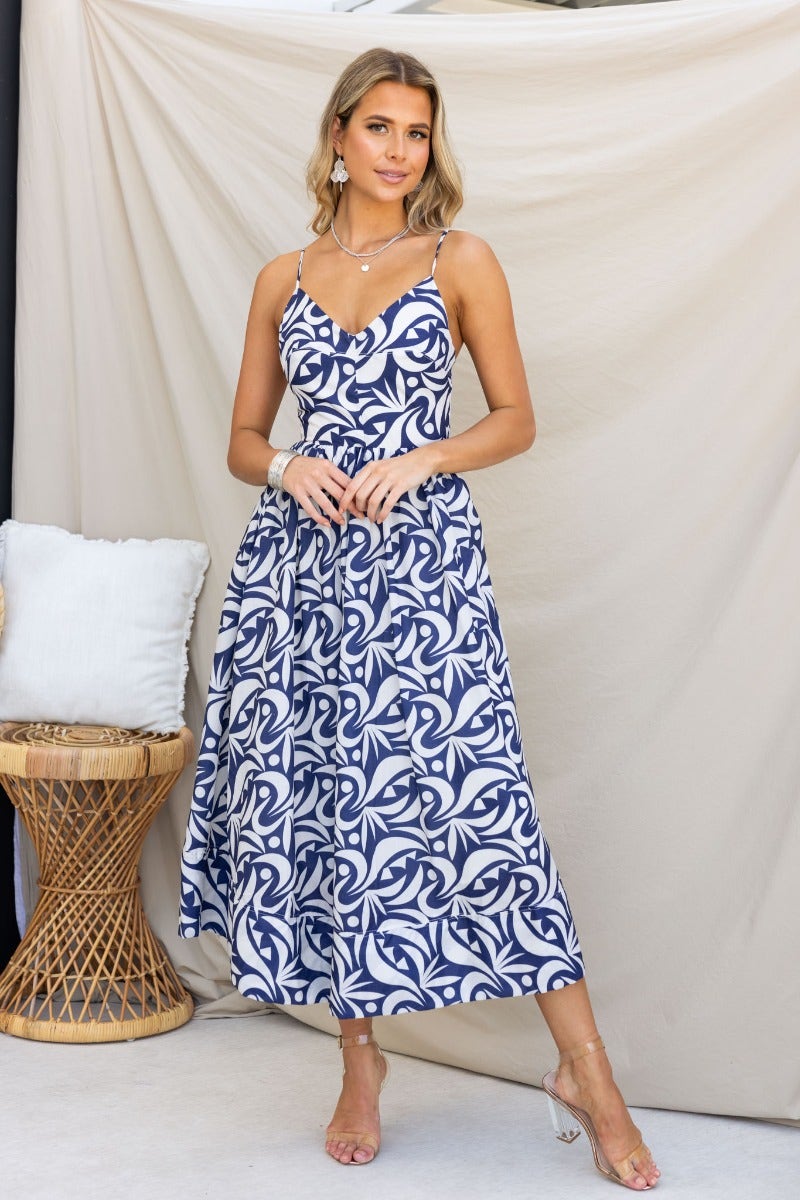 Vallere Maxi Dress in navy with a playful print, featuring adjustable straps and a flattering V-neckline.
