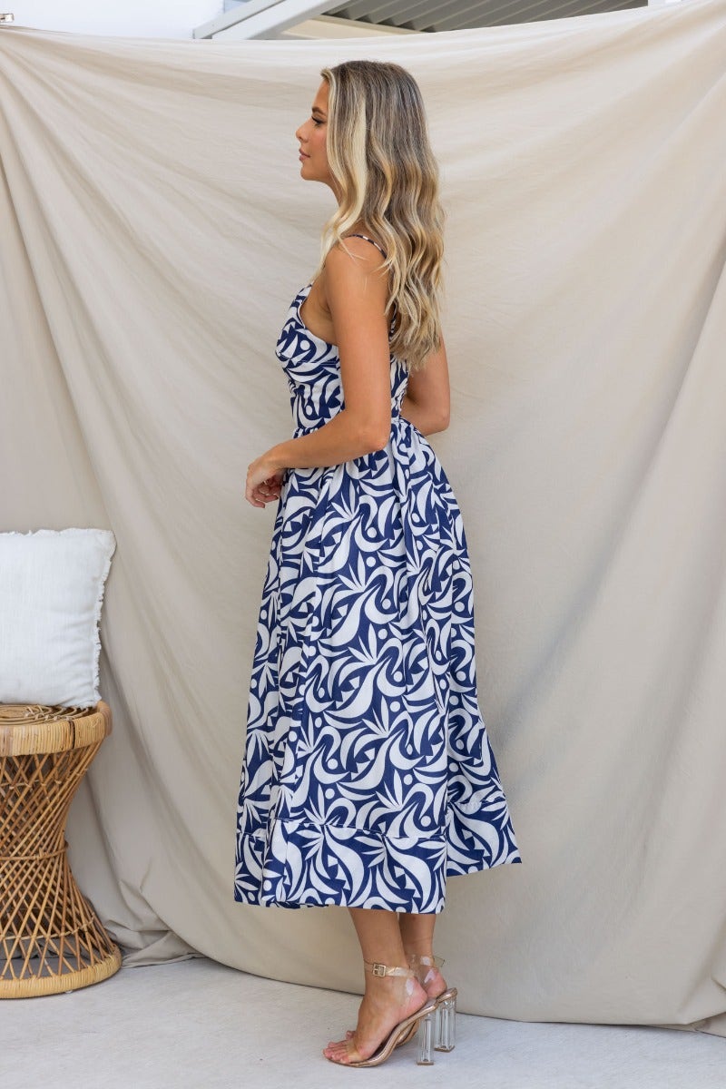 Vallere Maxi Dress in navy, featuring a patterned design, adjustable straps, and a flattering fit with pockets.