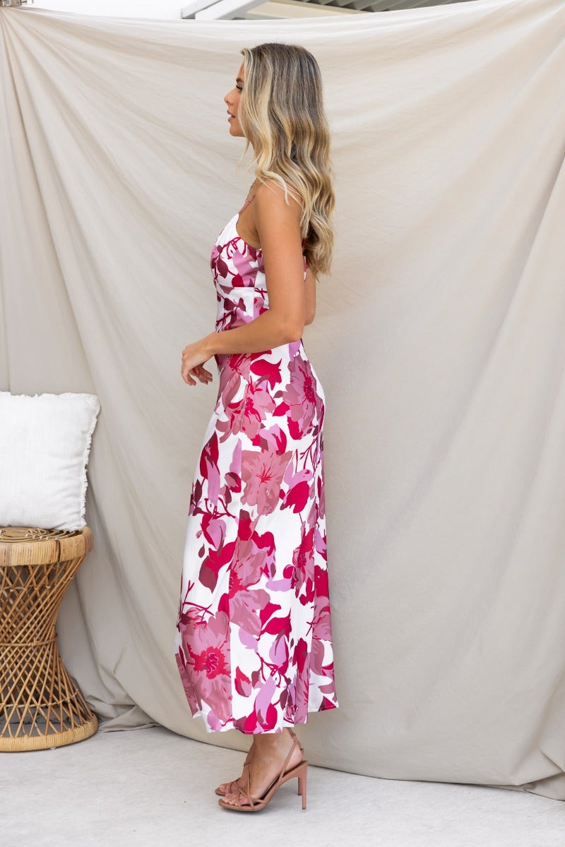 Brylee Maxi Dress featuring a floral design, adjustable straps, and cut-out back, model showcasing side view.