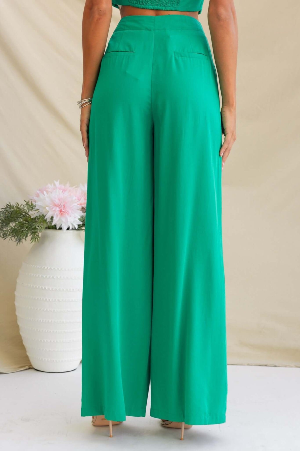 Back view of green Erik Pants featuring mid-high waist, faux back pockets, and wide-leg silhouette.