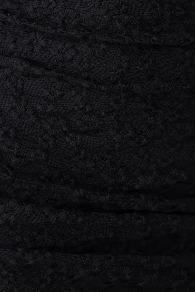 Close-up of black embroidered mesh fabric with ruching, showcasing the elegant texture used in the Told You So Midi Dress.