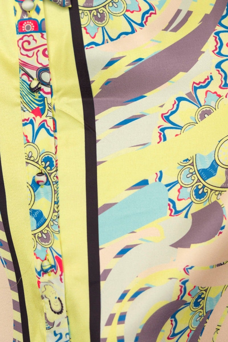 Close-up of the Nicosia Maxi Dress, featuring vibrant abstract print and button-up front with collar.