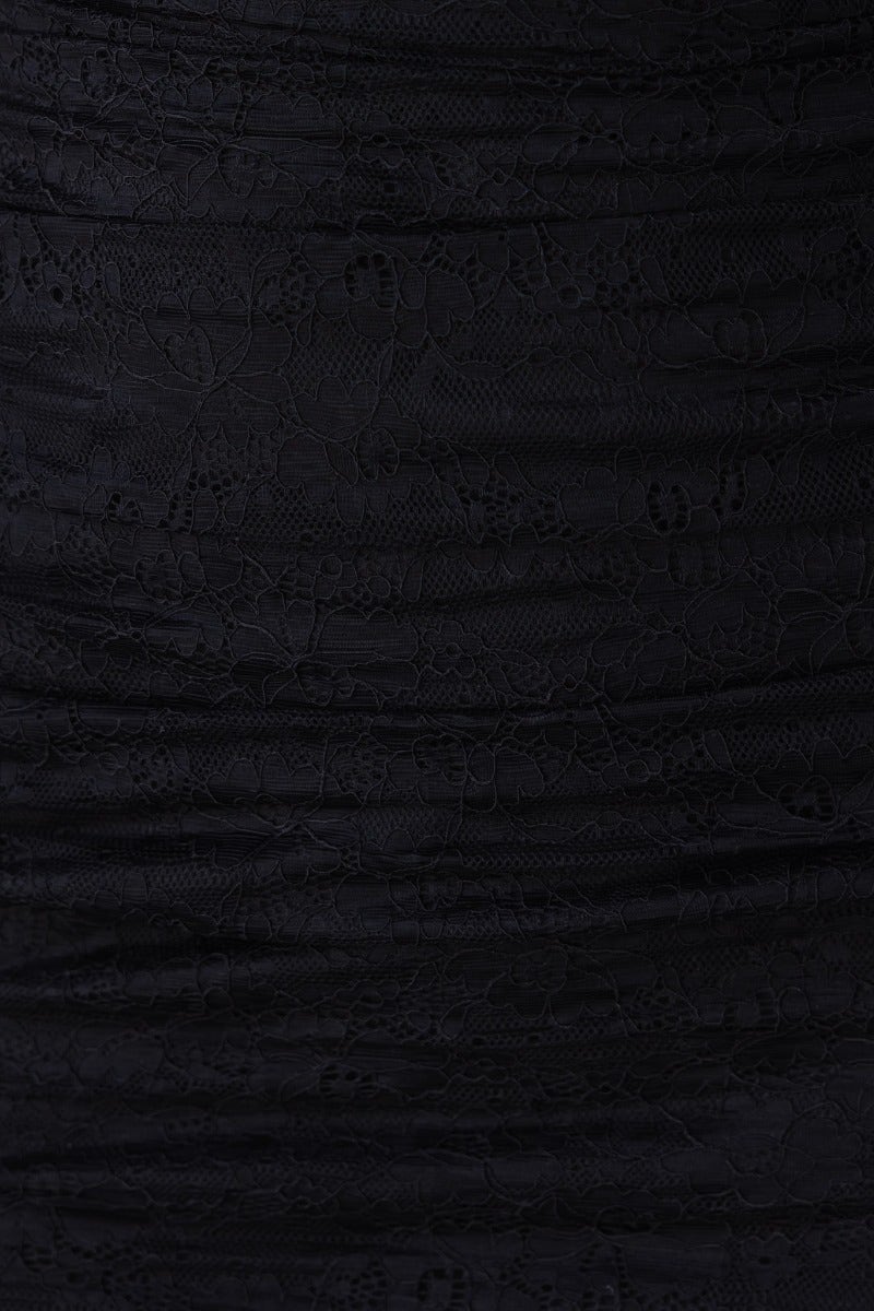 Close-up of black lace fabric with a draped, textured pattern, ideal for a sultry midi dress.