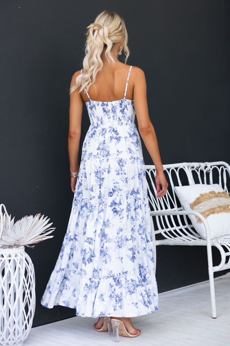Back view of a floral print Morea maxi dress with adjustable straps and pockets, styled for a relaxed look.