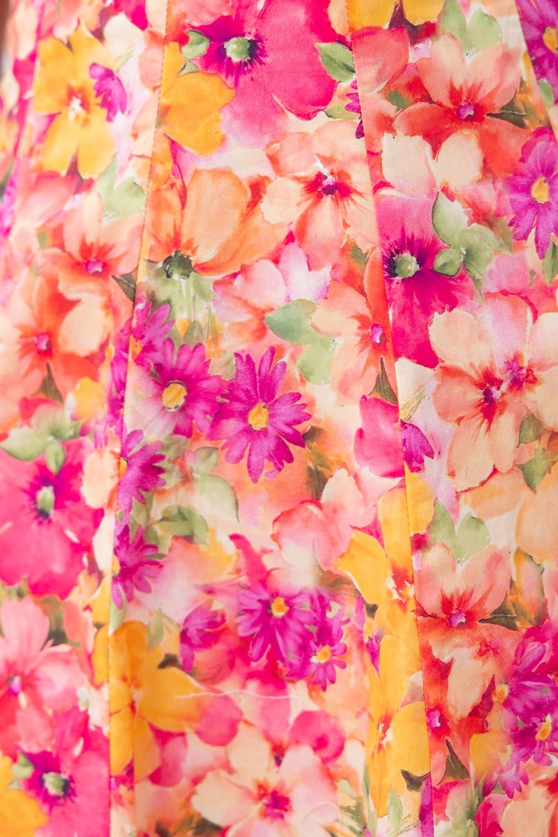 Close-up of the colorful floral print on the Thinking Out Loud Dress, showcasing vibrant pink and yellow flowers.