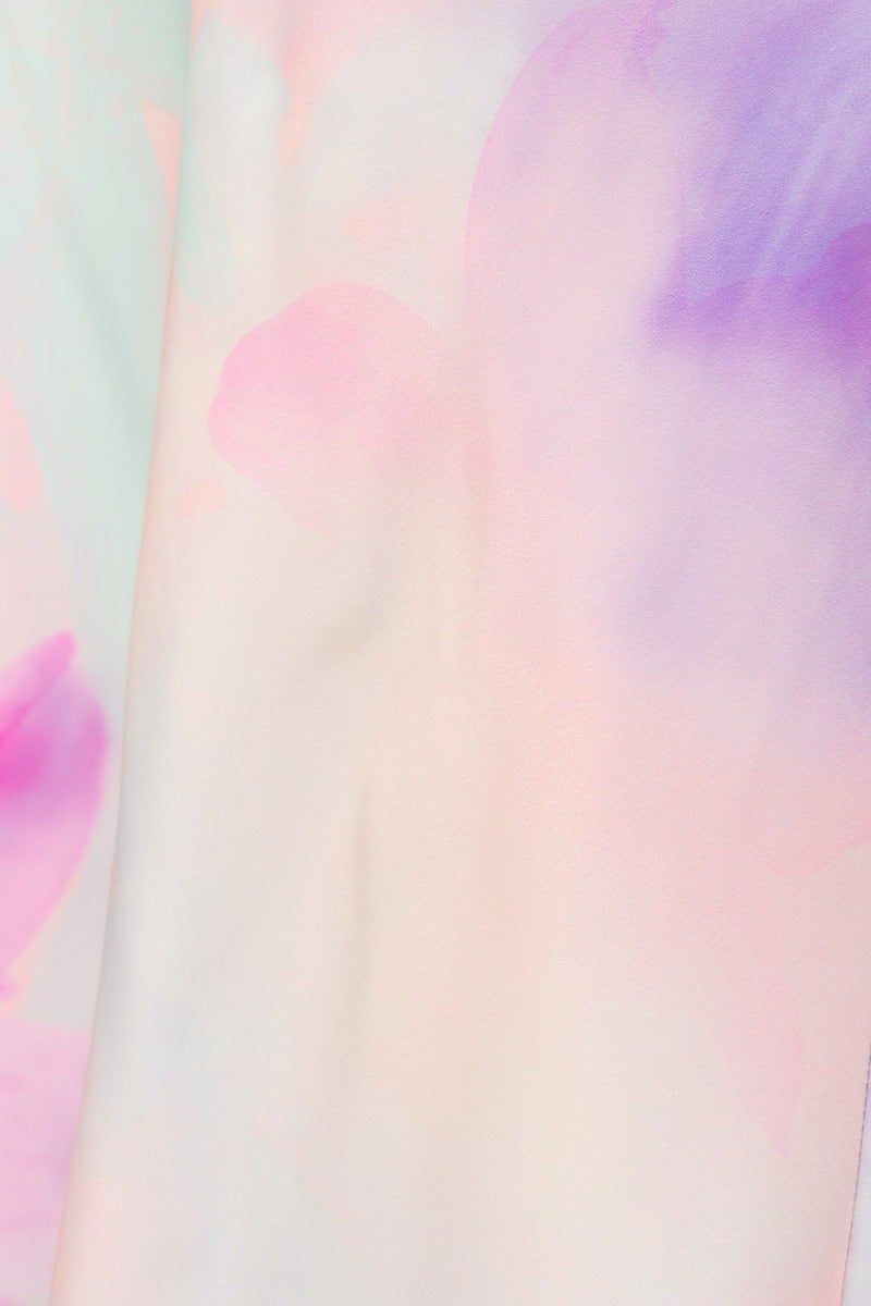 Close-up of soft, pastel floral print fabric in shades of pink and purple, ideal for a deluxe maxi dress.