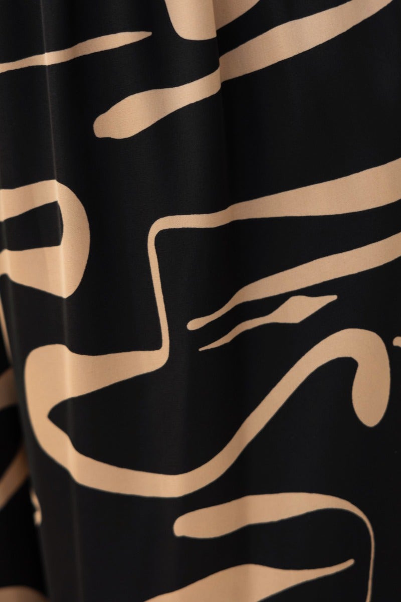 Close-up of the Up All Night Set fabric featuring black base with abstract beige line patterns.