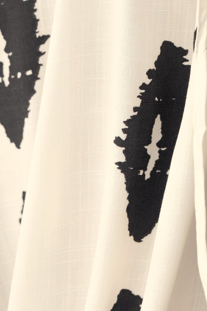Close-up of abstract black and white print on fabric, showcasing the texture of the Jarklin Maxi Dress.
