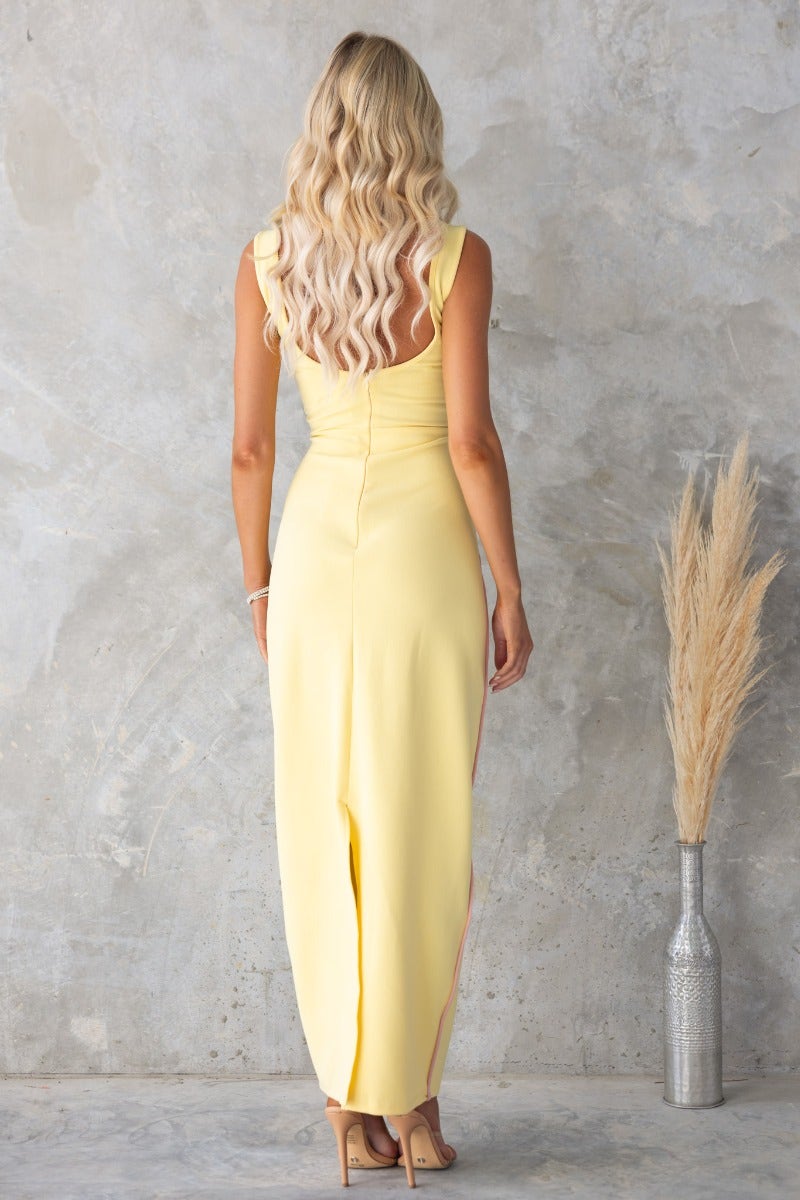 Back view of a stylish Heads Turn Maxi Dress in yellow, featuring a fitted design and split detail.
