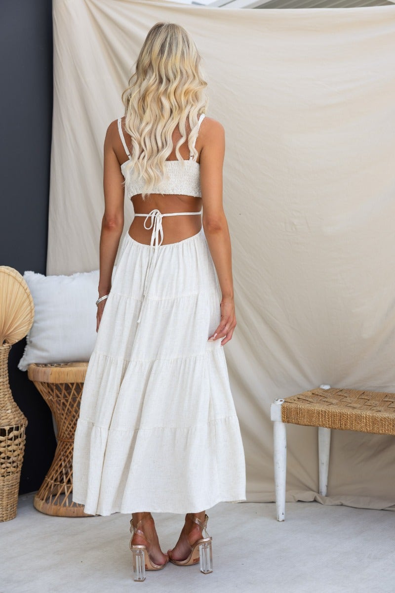 Back view of Brookman Midi Dress with adjustable straps, elastic back, and stylish cut-out waist detail.