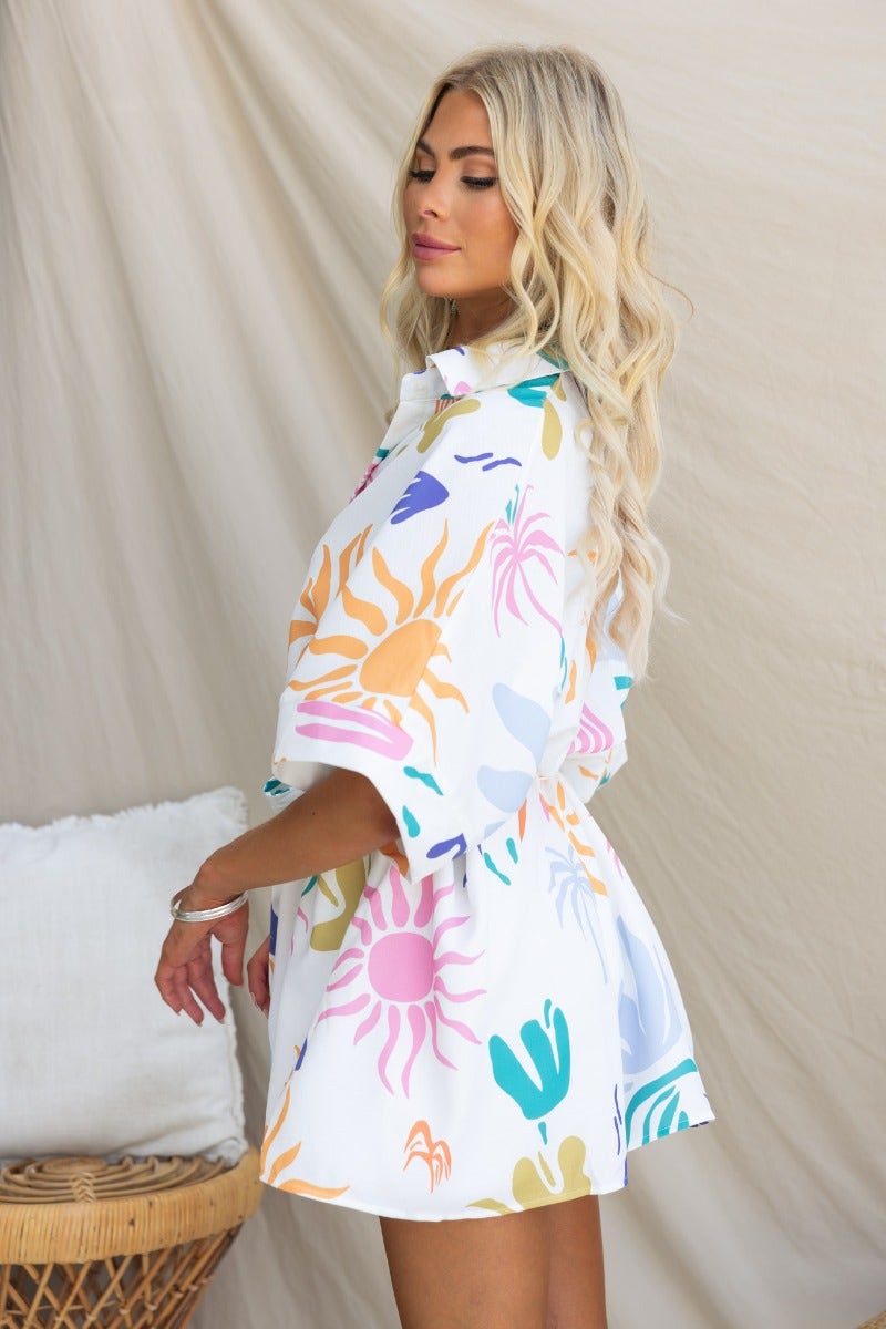 Model wearing the Leonie Playsuit featuring an abstract print, collar, and pockets, showcasing a relaxed fit.