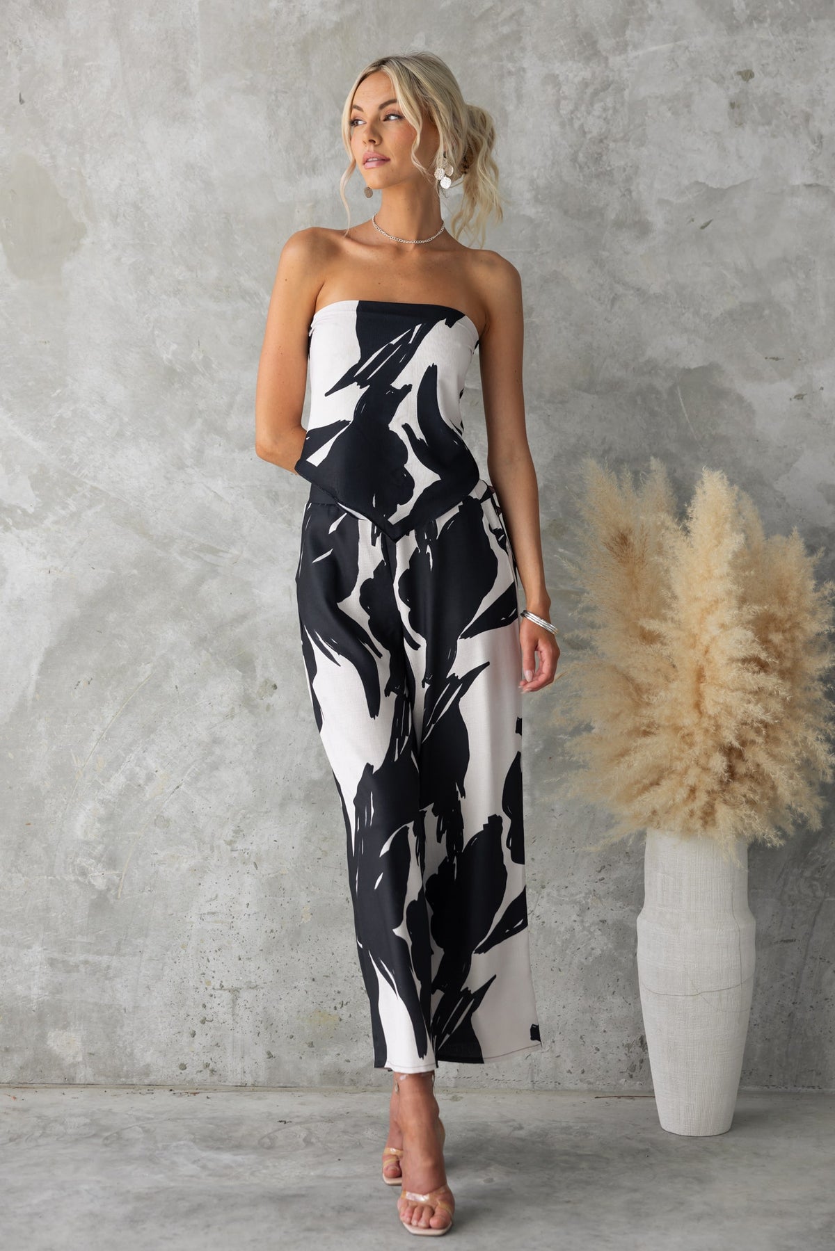 Model wearing Yanna Top, a black and white printed scarf-style top, showcasing a chic linen look.