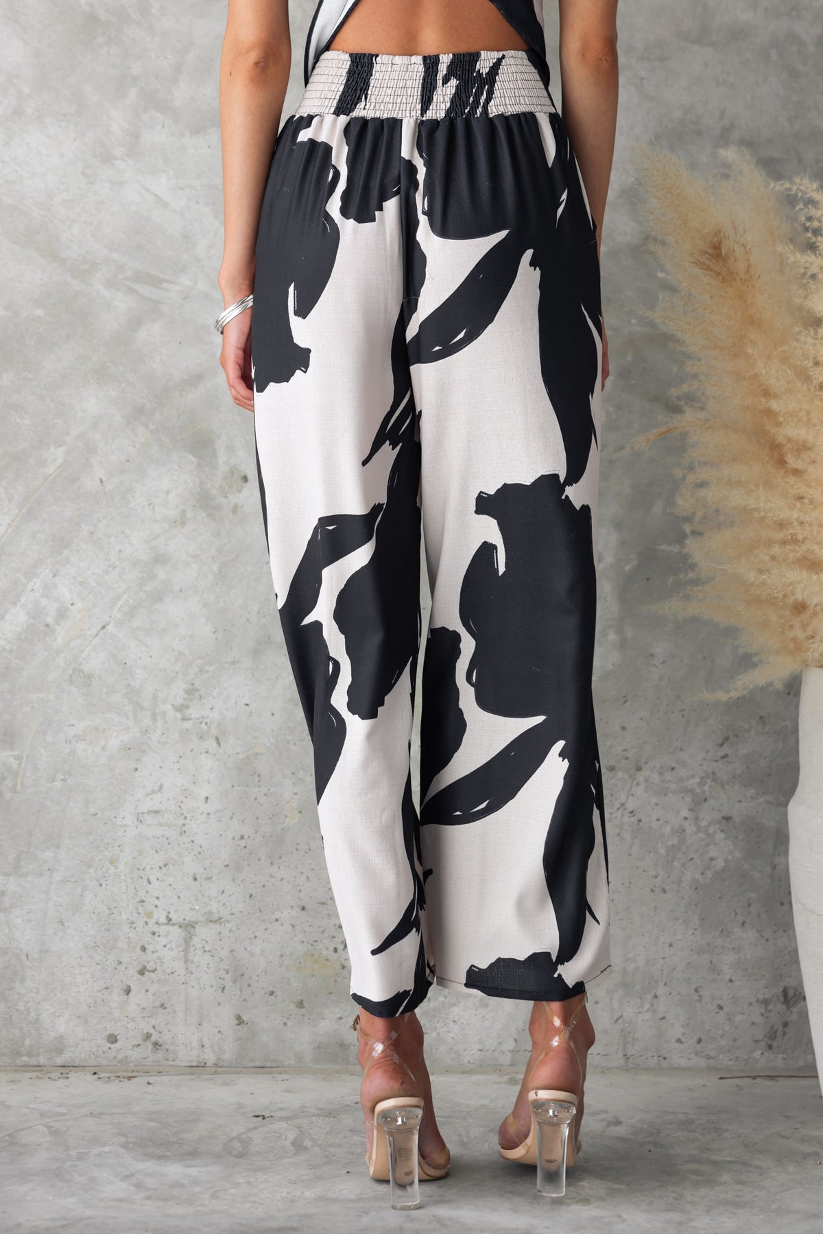 Back view of Yanna Pants featuring a black and white print, mid-high waist, elastic waistband, and casual fit.