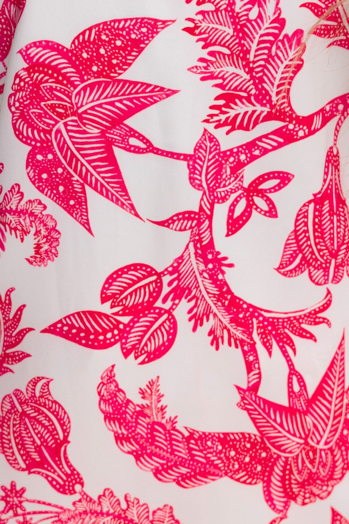 Close-up of vibrant pink floral print on Omika Midi Dress, featuring intricate design details.