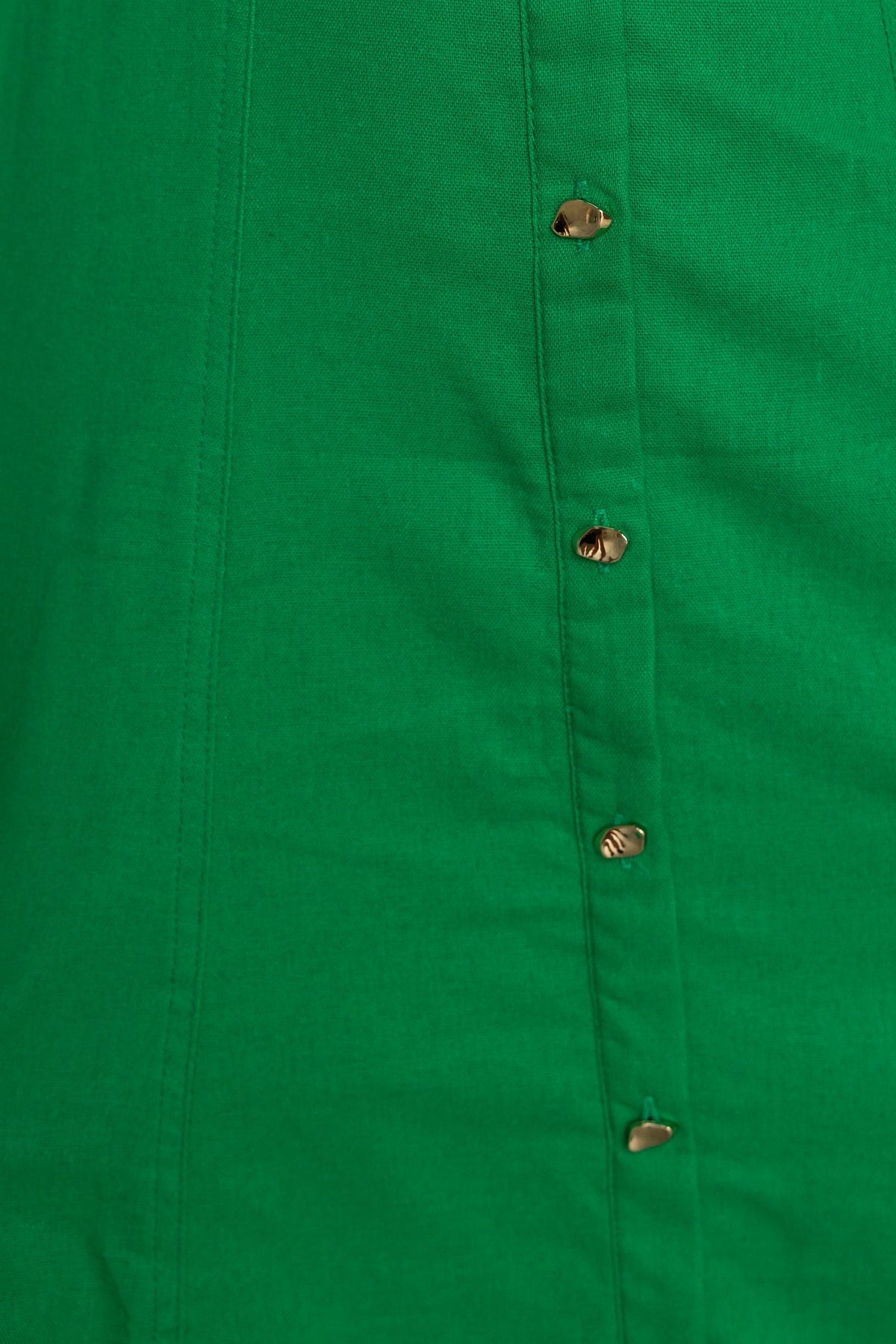 Close-up of the green Corella Midi Dress showcasing gold button details along the front.