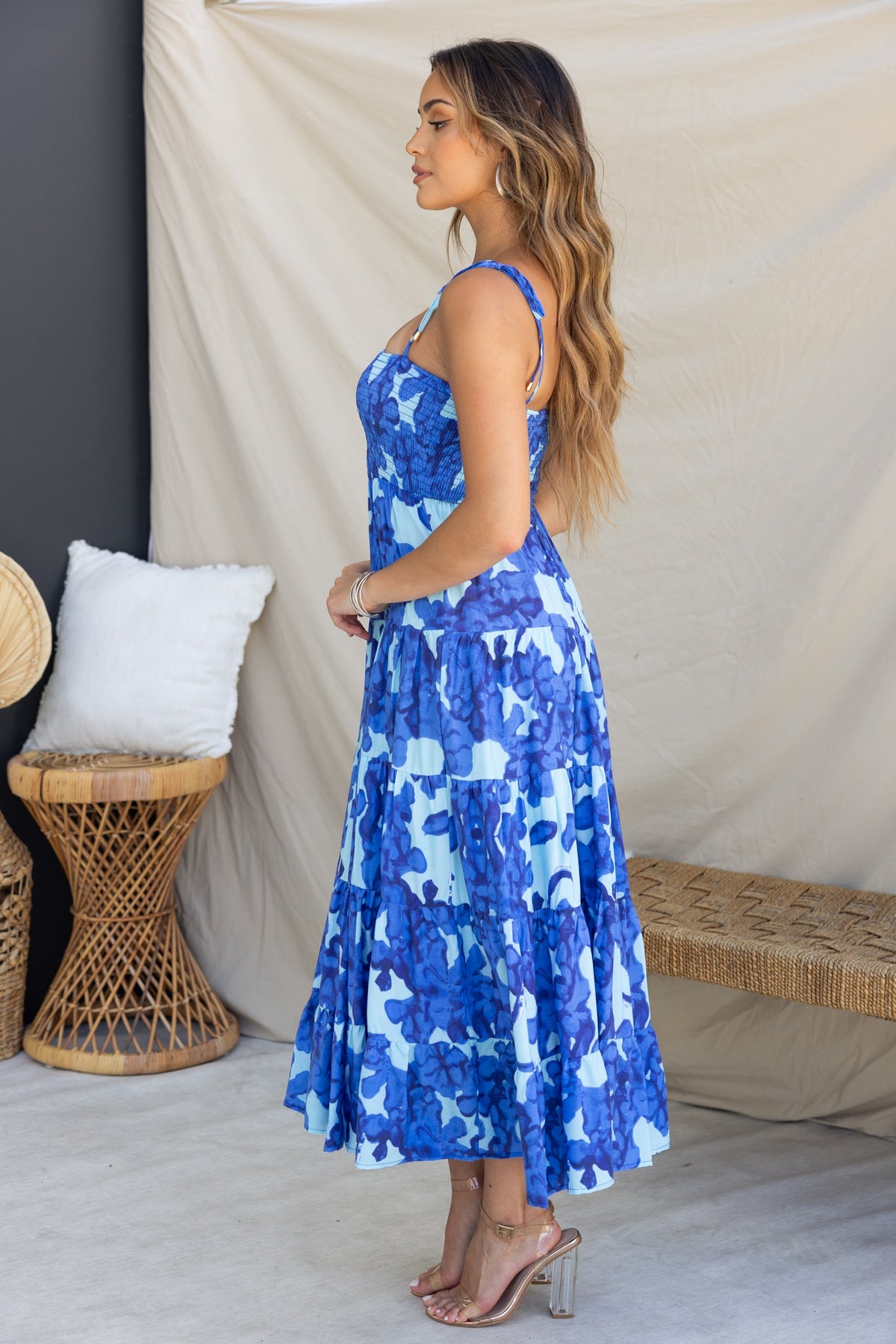 Inessa Midi Dress in blue floral print on model, featuring adjustable tie straps and flowy skirt.