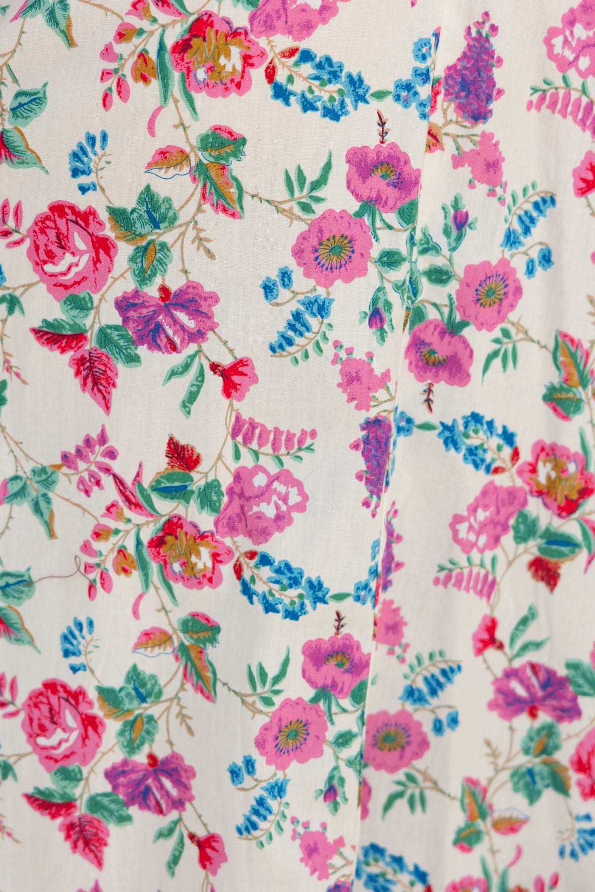 Floral print fabric featuring vibrant roses and greenery, designed for a stylish midi dress.