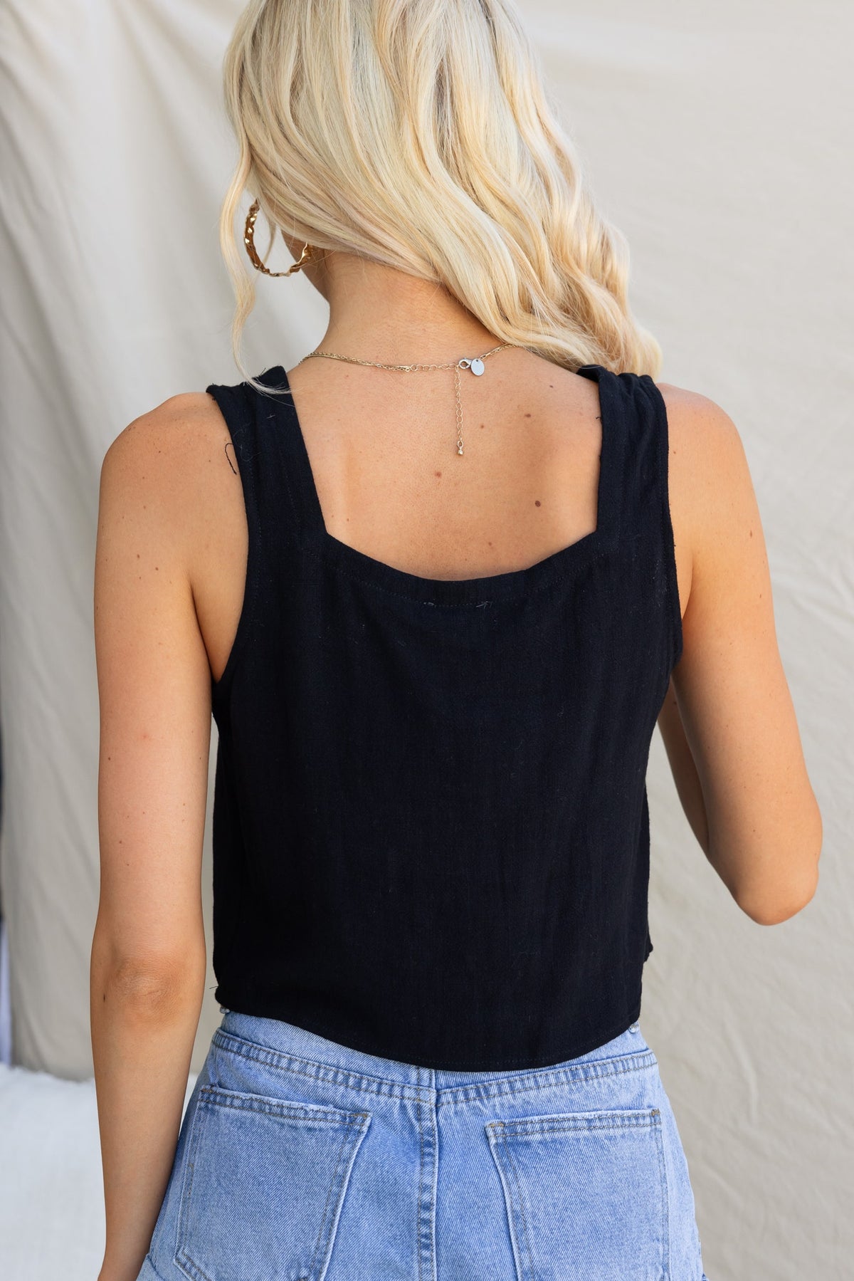 Back view of Jaye Top, a black linen-style square neck tank, features faux buttons and relaxed fit.