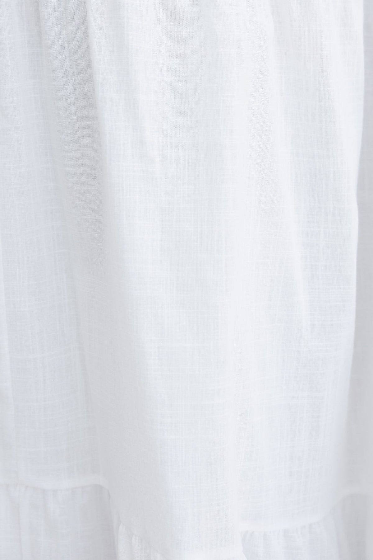 Close-up of lightweight, white fabric showcasing the soft texture of the Noya Maxi Dress.