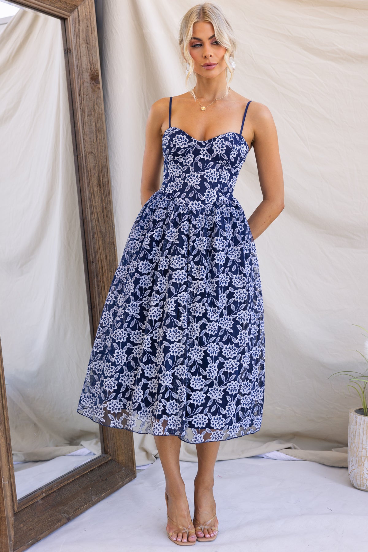 Model wearing an Ambient Midi Dress featuring lace material, adjustable straps, and tulle underlay.