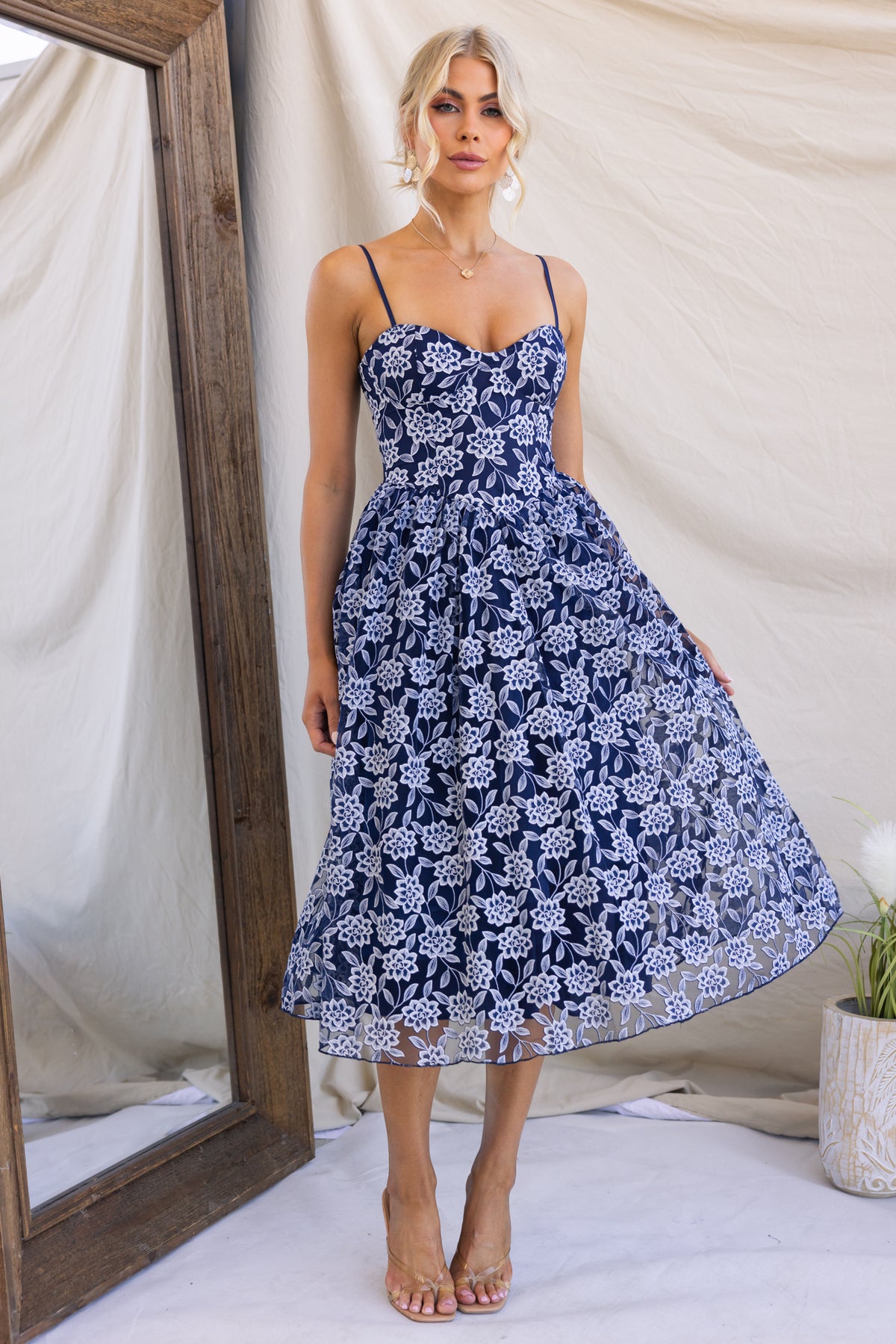 Ambient Midi Dress featuring lace material, adjustable straps, tulle underlay, and a flattering fit for elegant occasions.