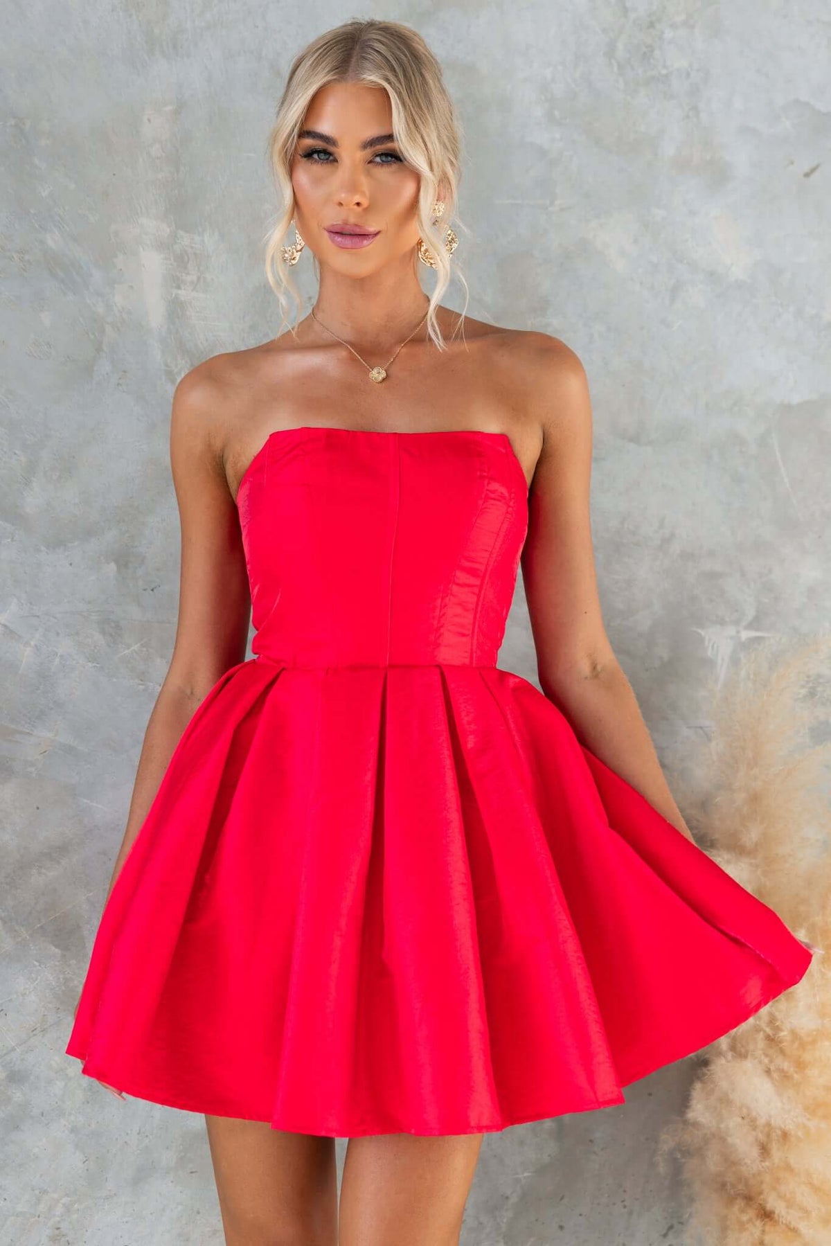 Aminah Dress: Strapless red satin dress with boning, tulle underlay, and a fitted bodice, featuring a flared skirt.