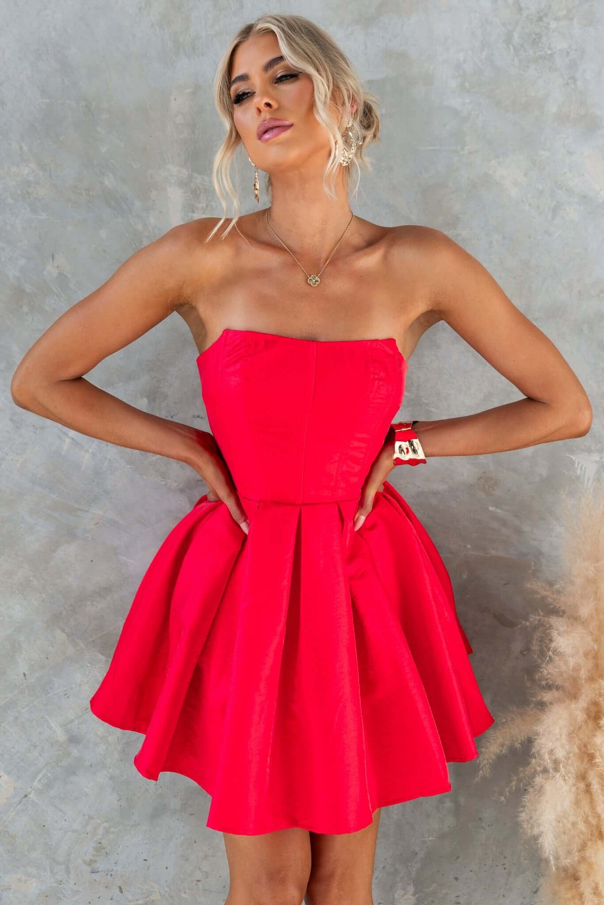 Aminah Dress: Strapless red satin dress with boning and tulle underlay, featuring invisible zip and a flared skirt.