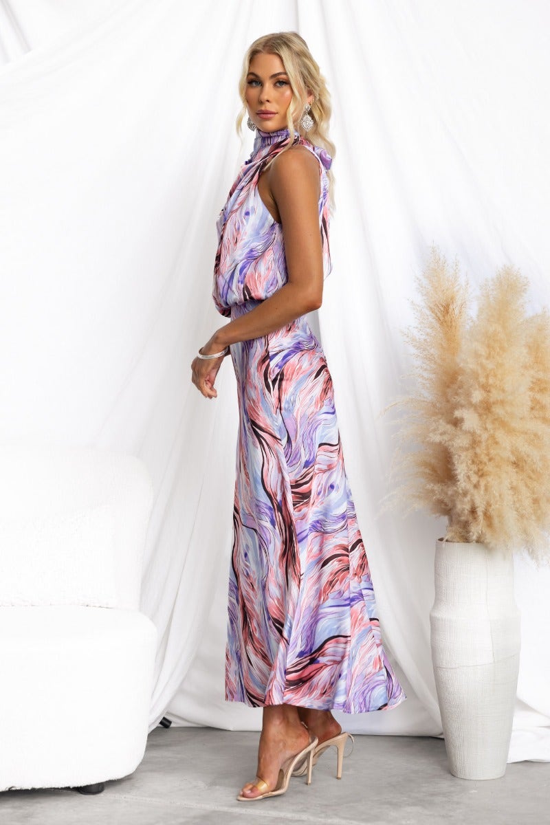 Admire Maxi Dress featuring a high neckline and vibrant swirl pattern, styled with a tie at the neck and satin finish.