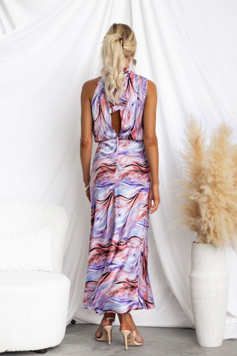 Admire Maxi Dress showcasing colorful satin fabric, high neckline, and open back design for a stunning evening look.