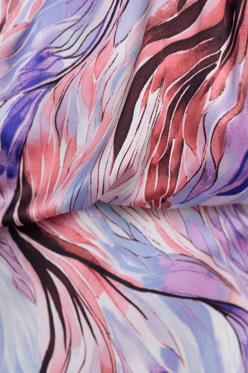 Close-up of flowing fabric featuring soft pastel colors and abstract wave patterns, highlighting the satin look of the Admire Maxi Dress.
