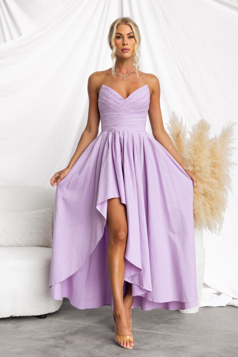 Elegant strapless Kiss And Tell maxi dress in lavender with asymmetric hem and boning detail.