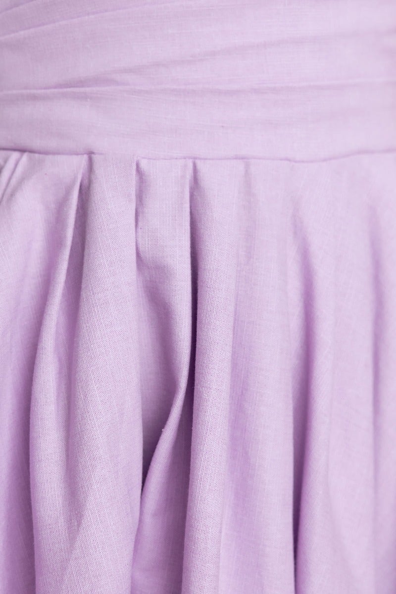 Detail shot of purple fabric pleats from the Kiss And Tell Maxi Dress, showcasing soft texture and elegant design.