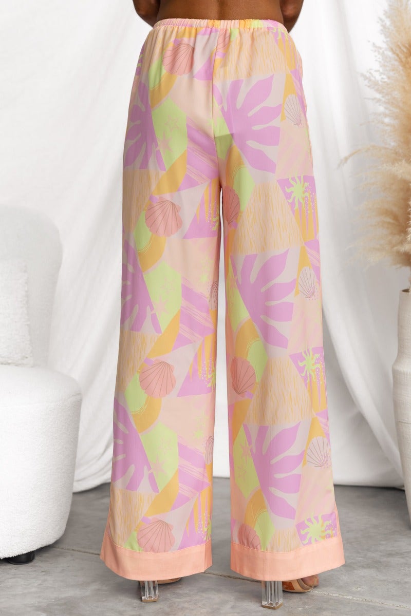 Back view of Ibiza Pants featuring abstract print, mid-high waist, elastic waistband, and light, non-stretch material.