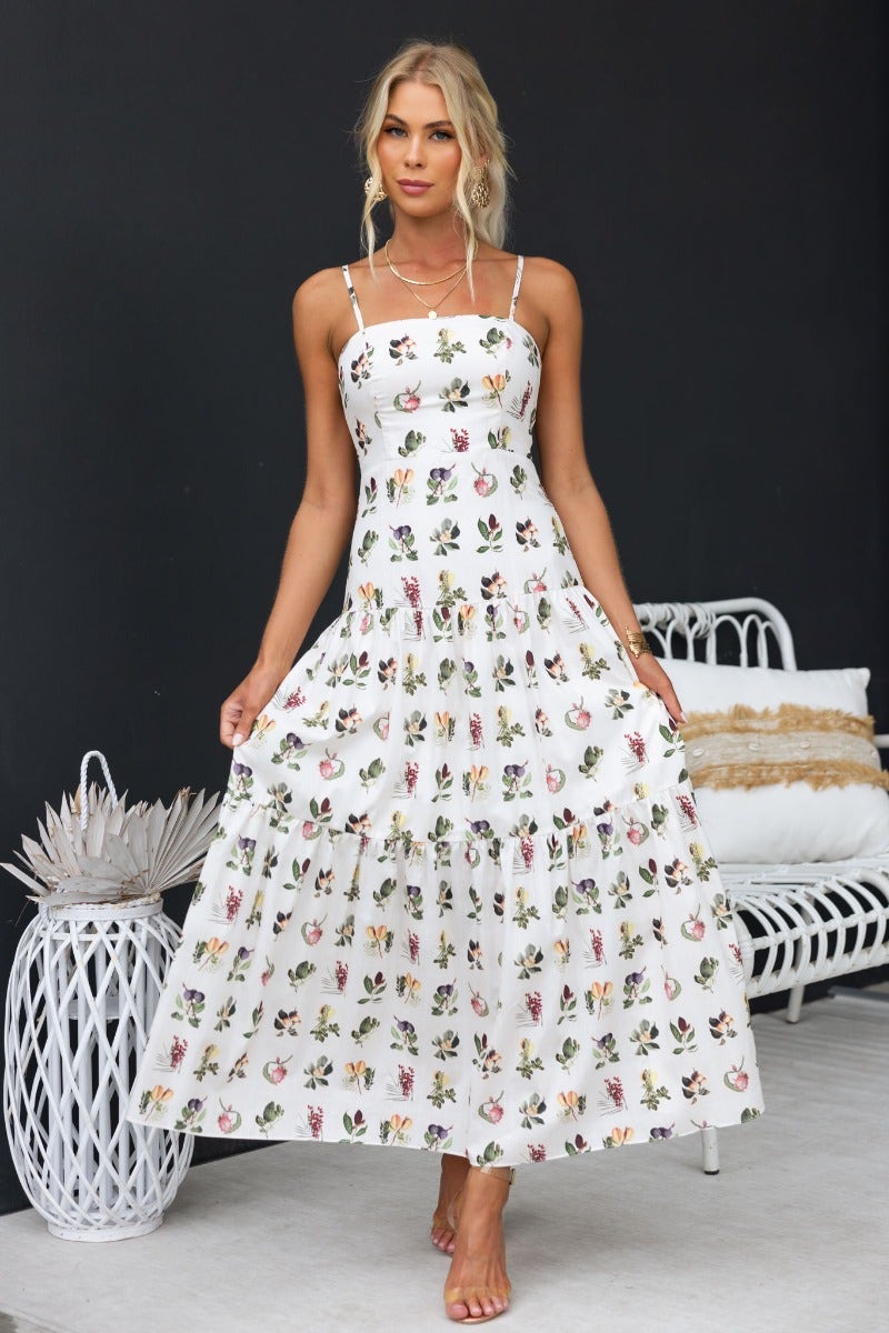 Carlyle Maxi Dress featuring floral print, adjustable straps, and lightweight cotton fabric, perfect for warm weather occasions.