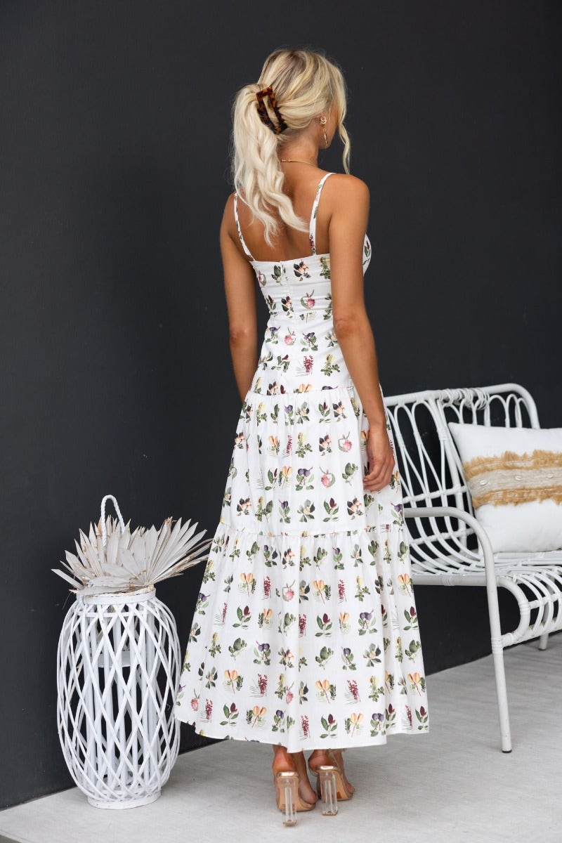 Back view of Carlyle Maxi Dress featuring floral print, adjustable straps, and lightweight cotton fabric.