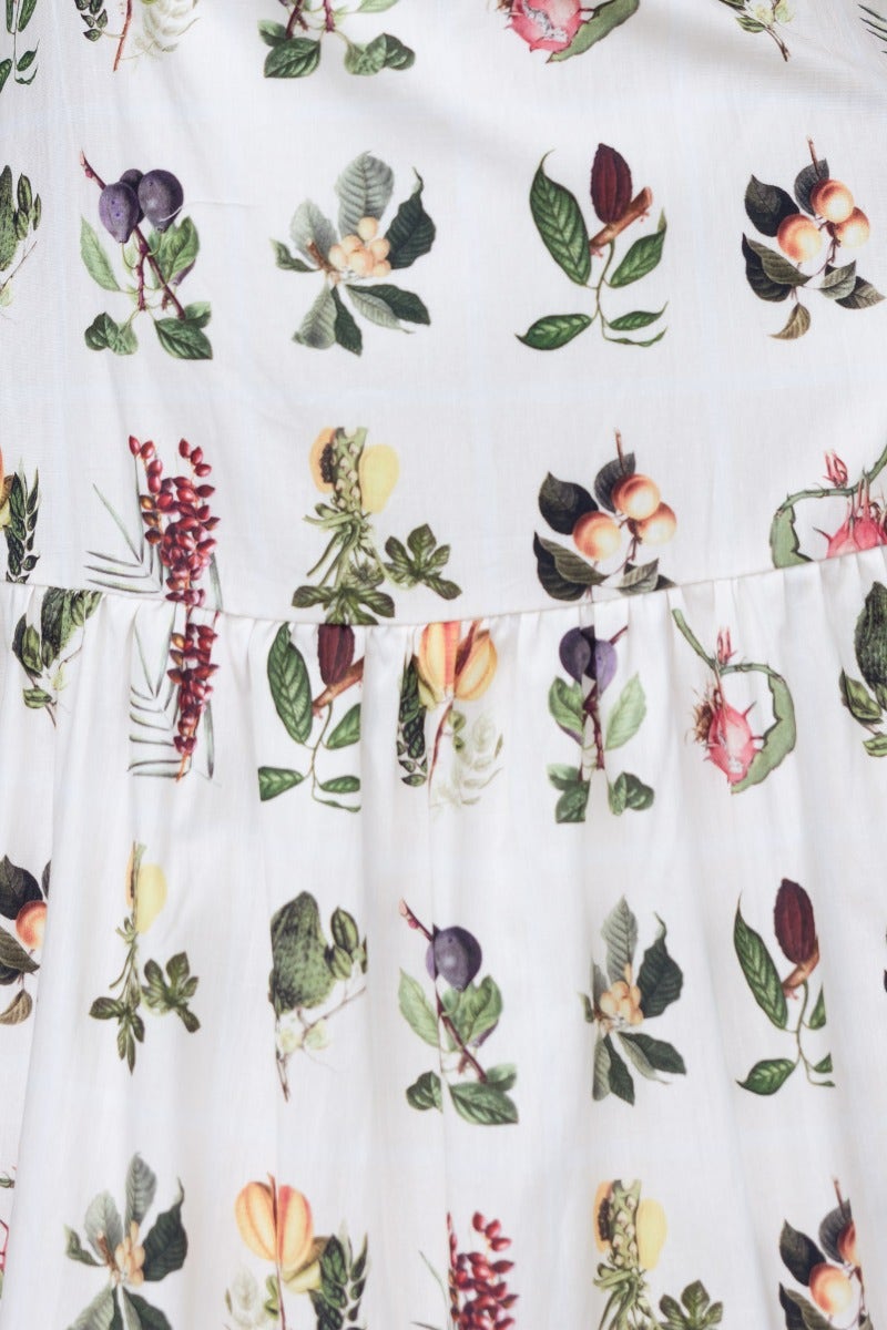 Floral print fabric of Carlyle Maxi Dress featuring vibrant botanical illustrations on a light cotton background.