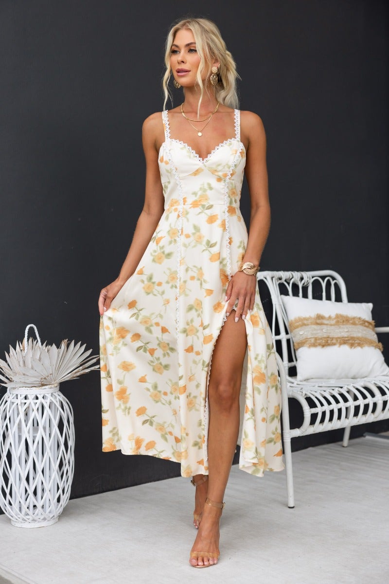 Brigita Midi Dress featuring floral print, adjustable straps and front split, styled with lace detailing.