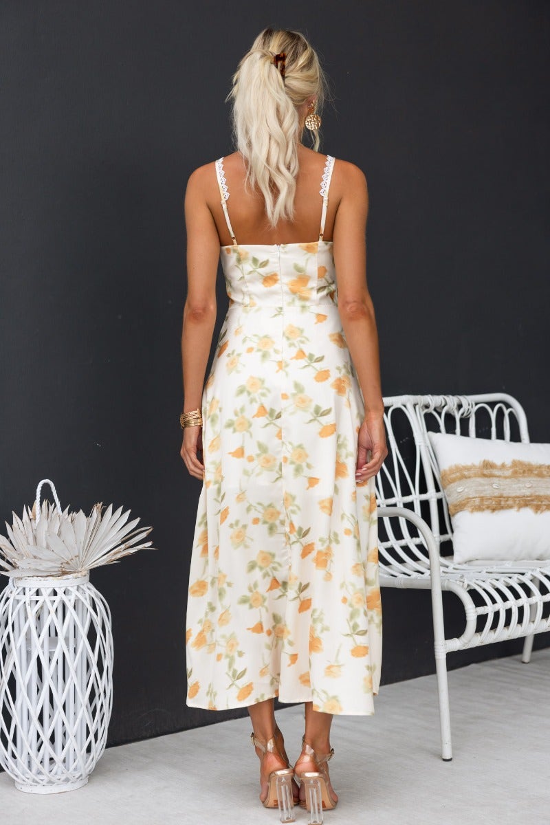 Back view of Brigita Midi Dress, featuring floral print and adjustable straps, perfect for summer occasions.