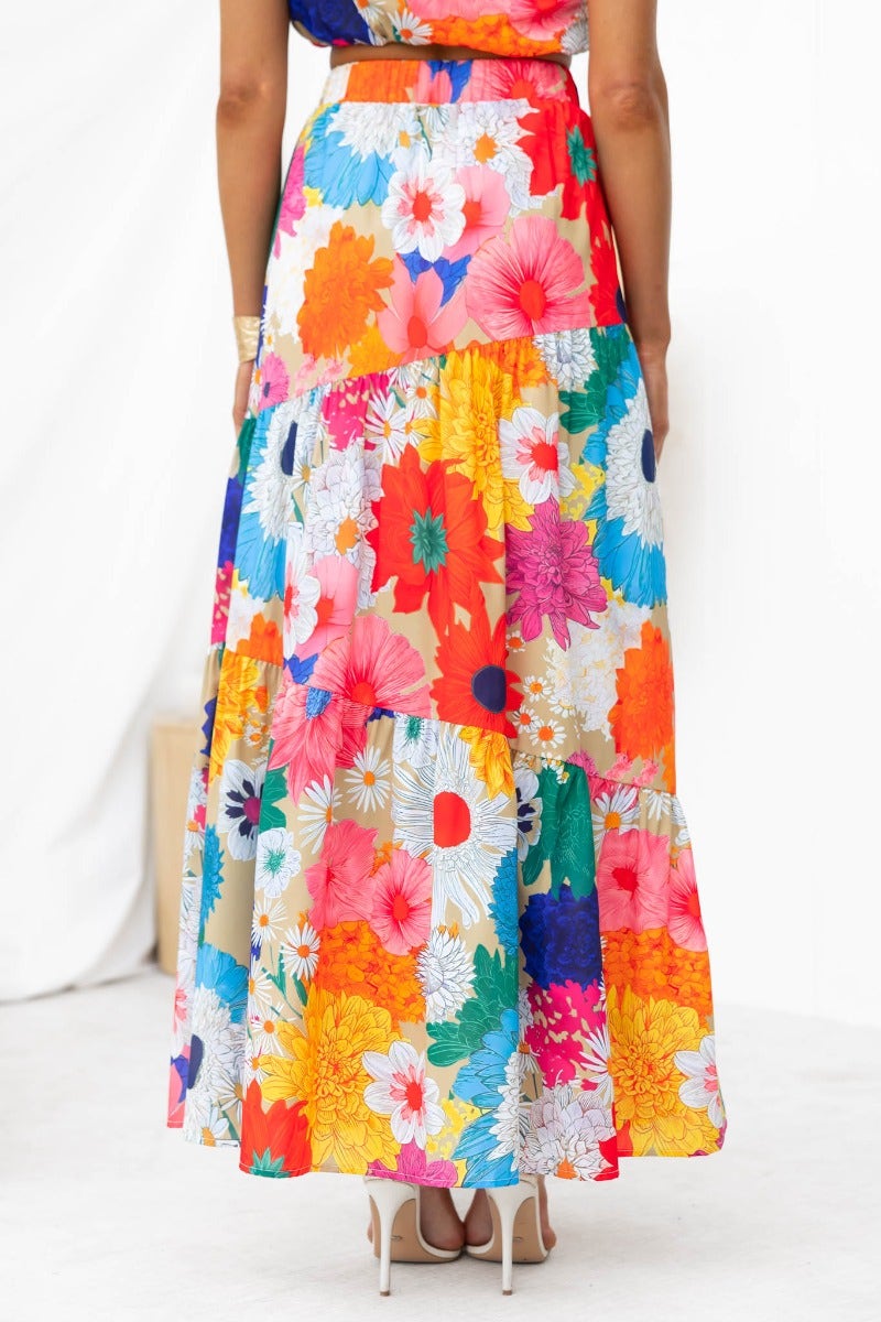 Colorful floral print maxi skirt with layered design and elastic waistband, showcasing vibrant flowers and mid-high waist fit.