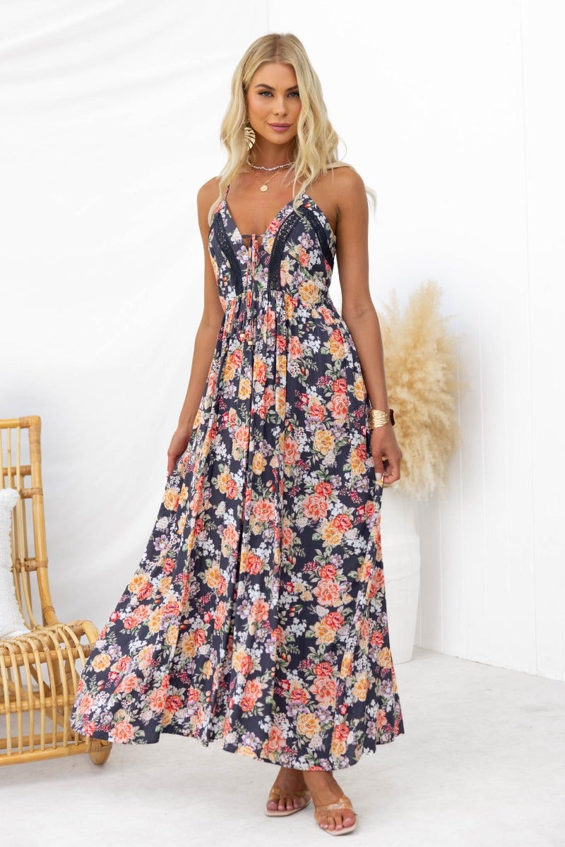 Montreal Maxi Dress: Floral print, black background, V-neckline, adjustable tie straps, and light material for summer style.