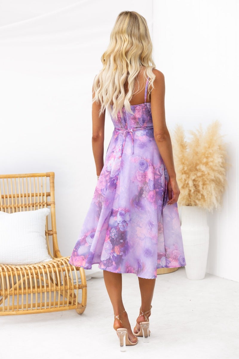 Back view of a floral print Treasure Today midi dress with adjustable straps, lace details, and a structured feel.