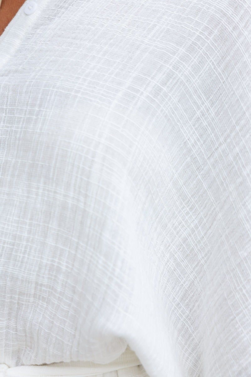 Close-up of lightweight, textured white fabric showcasing the soft, breathable cotton material of the Rowson Playsuit.