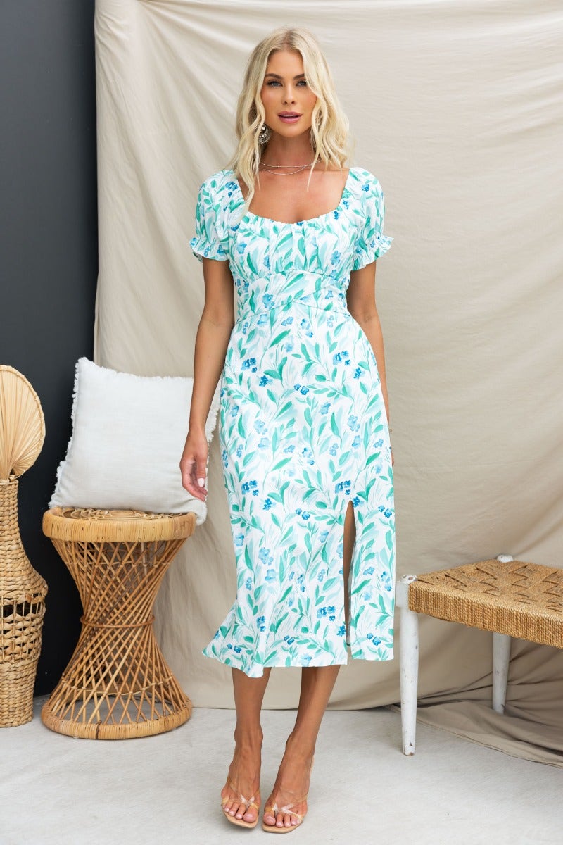 Floral print Teava midi dress with sweetheart neckline and front split, styled with elastic sleeves and pockets.