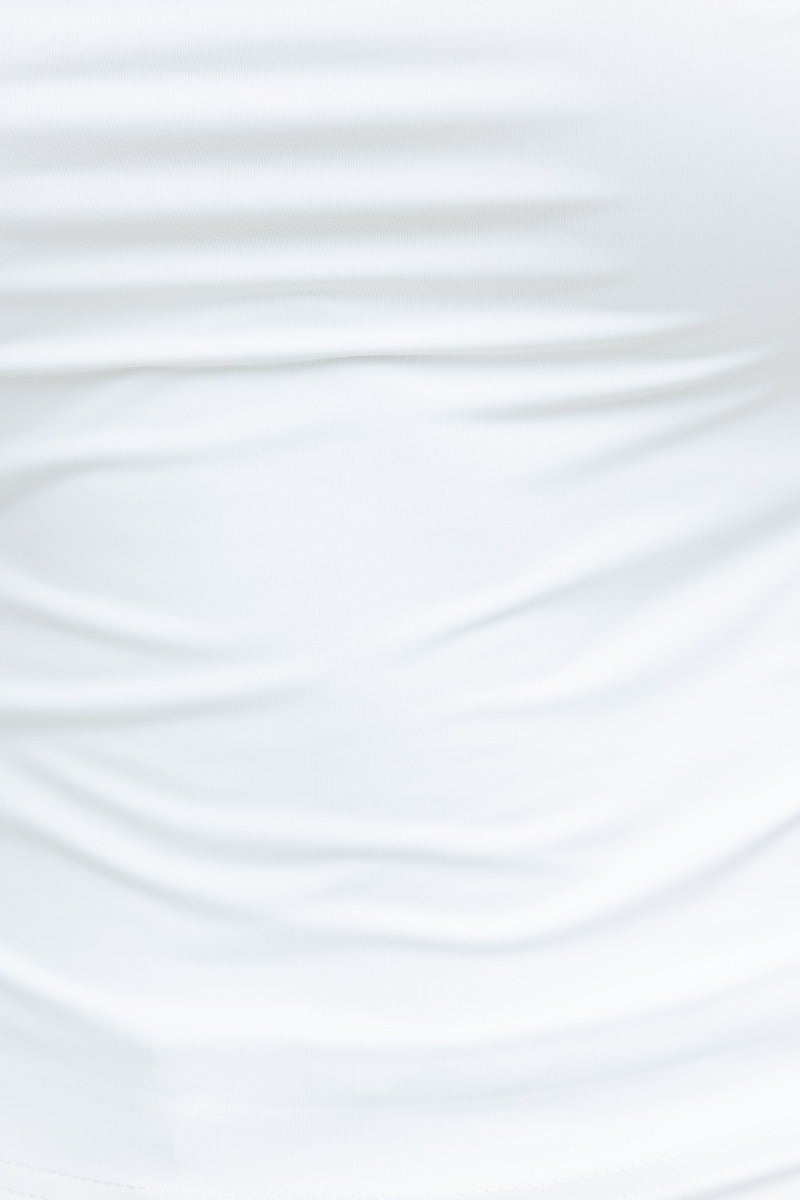 Close-up of white Slinky material top featuring square neckline and soft, stretchy fabric for a comfortable fit.